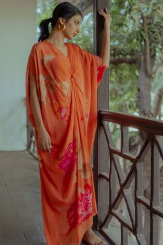 Editor's Note Our Anar And Rose Placement Print Kaftan In Sherbet Orange Comes With A Knot Detailing In The Front Is Perfect For A Leisure Vacation Color: Orange Fabric: Pure Crepe Care: Dry Cl... Orange Kaftan, Paulmi And Harsh, Goa Outfits, Kaftan Sleeves, V Neck Kaftan, Strong Feminine, Blouse Yoke, Kaftan For Women, 1950’s Fashion