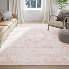 a living room area with couches, chairs and a rug in front of a window