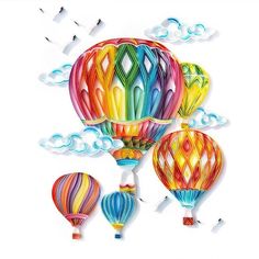 three colorful hot air balloons floating in the sky with clouds behind them and paper cutouts below