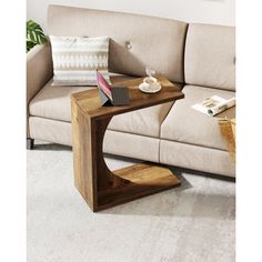 a wooden table sitting on top of a white carpeted floor next to a couch