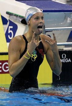 a woman standing in the water with her mouth open