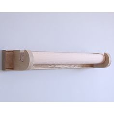 a white wall with a wooden handle on it