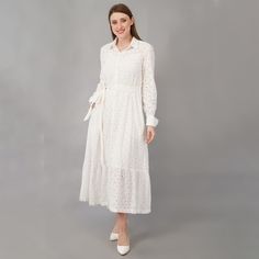 This eyelet shirt dress in white color of cotton is the epitome of class. The perfect summer dress is a must have for all the occasions. - Shirt collar neck - Flared silhouette - Long sleeve - Ankle length - Button down - White cotton fabric belt - Pockets on both the sides - includes cotton slip Color - white  Fabric - 100% cotton eyelet SIZES: Please see the size chart image and pick the size that works for you. We are happy to make minor alterations to help create the right fit. Please let us know.  CUSTOMIZATIONS: We are happy to make minor adjustments to help craft the perfect fit.  PLEASE NOTE what you get may not match exactly with the photos and may vary slightly in color and pattern due to lighting and camera settings. We try to be as true as possible to the photographs and are ha White Button-up Feminine Shirt Dress, White Feminine Button-up Shirt Dress, White Long Sleeve Eyelet Dress, White Eyelet Midi Dress For Day Out, White Button-up Feminine Midi Dress, White Shirt Dress For Spring, White Cotton Button-up Midi Dress, White Cotton Shirt Dress For Daytime, Shirt Dress With Pockets