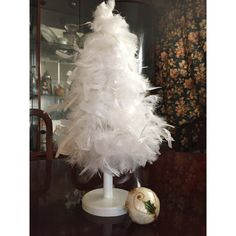 a white christmas tree sitting on top of a table