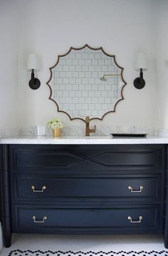 an image of a bathroom vanity with blue drawers and gold handles on the counter top