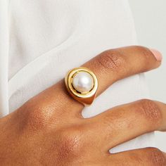 The Mini Signet Ring contrasts our signature brushed finish with a high polished, double-layered rim surrounding a round and lustrous pearl. Details: Gemstone: Saltwater Pearl Gemstone Diameter: 10mm Modern Round Pearl Ring In Yellow Gold, Modern Pearl Ring For Formal Occasions, Modern Pearl Open Ring With Polished Finish, Elegant Dome Ring With Smooth Bezel, Modern Oval Pearl Ring For Anniversary, Modern Round Pearl Rings, Modern Wedding Pearl Ring, Modern Pearl Rings For Anniversary, Modern Pearl Rings