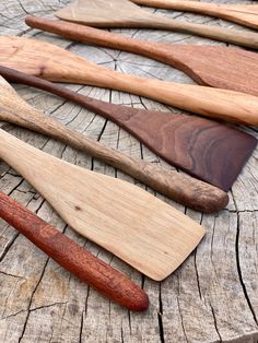 wooden spoons lined up on a piece of wood