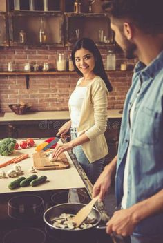 a man and woman preparing food in the kitchen royalty images, stock photos & more