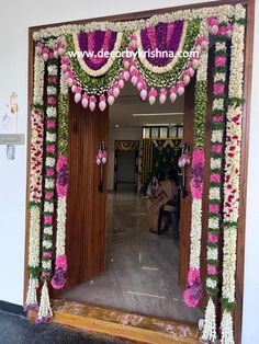 an entrance decorated with flowers and garlands