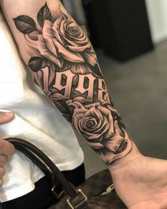 a woman's arm with roses and the word aro tattooed on it