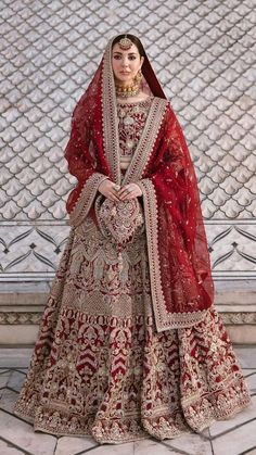 a woman in a red and gold bridal gown