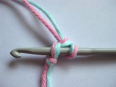 a crochet hook with two colored yarn wrapped around it