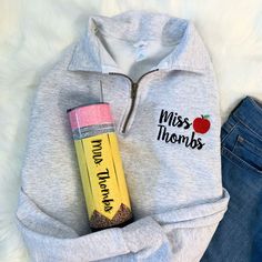 a sweatshirt that says miss thomas with an apple on it and a pencil in the pocket