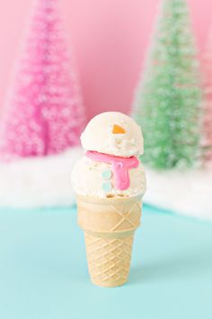 an ice cream cone with a pink frosting on top