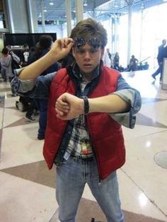 a young man is standing in an airport