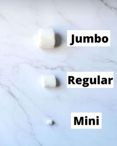 the words jumbo, regular and mini are written in white letters on a marble surface