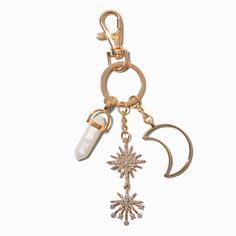 a gold key chain with an ice and snowflake charm hanging from it's side