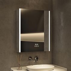 a bathroom sink sitting under a mirror in front of a wall mounted faucet