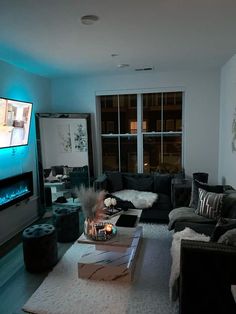 a living room filled with furniture and a flat screen tv mounted to the side of a wall