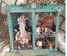 there is a shelf with shells and figurines in it