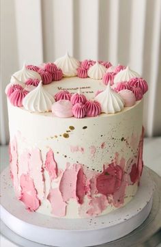 a cake with pink and white frosting on top