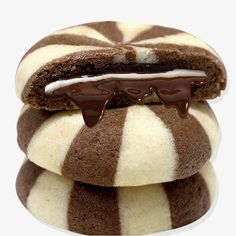 three chocolate covered cookies stacked on top of each other