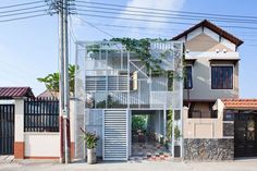 an apartment building with vines growing on it's sides and doors open to let in light