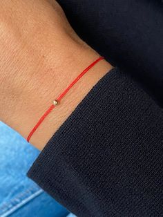 This red string bracelet is made from silk cord and solid gold or sterling silver 3 mm bead. Wish bracelet is a beautiful way to give someone you care for a wish. All they have to do is make a wish and then tie the cord around their wrist. When the cord finally wears down and breaks the wish is released and will come true - so they say! Details: * 14K solid gold or sterling silver bead - 3 mm; Silk String * Adjustable clasp; Bracelet is adjustable, so it will fit for everyone. If you need man si Silk Thread Bracelet, Red Bracelet Tattoo, Red Bracelet Ideas, Red Bracelet Diy, Red Bracelet For Protection, Red Thread Bracelet, Braided Bracelet Diy, Pretty Jewelry Necklaces, Red Bracelet