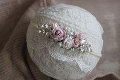 a white headband with pink flowers and pearls