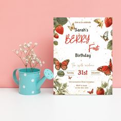 a birthday card next to a blue watering can with flowers in it and a pink background