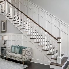 a living room filled with furniture and a stair case