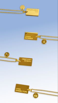 four different types of gold tags hanging from chains