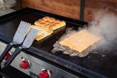 two waffles are cooking on an outdoor grill