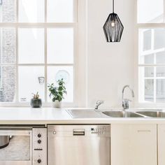 a kitchen with an oven, sink and dishwasher in it's center island