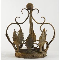 a metal crown with leaves and scrolls on it