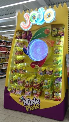 a toy food vending machine in the middle of a grocery store aisle with lots of products on display