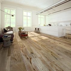 a living room filled with furniture and wooden floors