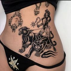 a woman's stomach with tattoos on it and an image of a lion, demon, and star