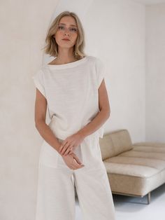 An easy, Everyday Top in our luxurious slub cotton fabric. This minimalist top features a wide neckline, slightly boxy body and mid-to-cropped length, perfect for tucking into our Everyday Crop or wearing with your favorite jeans. Our Ivory colorway is a warm ivory, undyed to highlight the beauty of natural cotton. Due to the undyed nature of our ivory cotton slight variations in color may occur. Made with Organic Cotton Handmade in India Machine wash cold on delicate cycle, lay flat to dry, war Chic Boxy Tops For Everyday, White Linen Top For Loungewear, White Linen Tops For Loungewear, Boxy Top For Summer Loungewear, Chic Boxy Fit Cotton Top, Versatile Linen Tops For Loungewear, Chic Boxy Fit Tops For Summer, Chic Boxy Fit Summer Tops, Minimalist Top