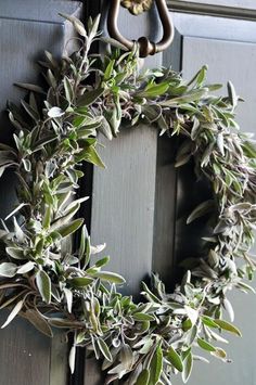 an olive wreath hangs on the front door