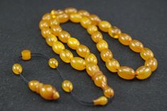 Tesbih Amber Rosary Original Prayerbead Handmade Rosary Kehribar Tesbih Beads Amber Tesbih Misbaha Islamic Prayer Beads Tasbih Tespih Prayer beads with 33 beads Bead size: 8 x 11.5 mm The rosary is completely handmade and a work of mastery. It has a perfectly processed and durable hand-knitted rope tassel. PRICE INCLUDES SHIPPING Please note: We offer the item in a variety. Variations in the size of the imams or beads are possible. Color deviations are also possible Note: Amber can change color over time due to abrasion and use. On warm days or due to prolonged use, the surface may feel more supple. Amber should be dry cleaned frequently to occasionally with cotton or similar cloths. We try to take photos that look as real as possible. However, it cannot be ruled out that color deviations Adjustable Amber Handmade Rosary, Traditional Adjustable Rosary With Polished Beads, Traditional Adjustable Amber Beads, Traditional Amber Rosary With Round Beads, Traditional Amber Rosary, Rope Tassel, Handmade Rosary, Islamic Prayer, The Rosary