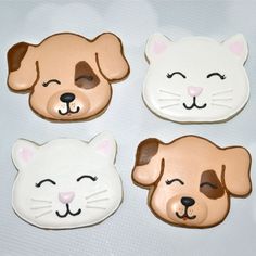 there are four cookies shaped like cats and dogs