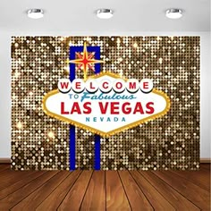 the welcome to fabulous las vegas sign in front of a gold sequin wallpaper