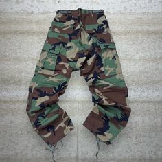 "Vintage Military Camo Tactical Pants Baggy Fit Double Knees Small Regular 90s Skate / Streetwear Great Condition: 9/10 Men's Size:  Waist: 28\" Length (inseam): 30\" Leg Opening: 8\" Thigh Opening: 12.5\" Front Rise: 12.5\"" 90s Style Cargo Pants For Streetwear With Side Pockets, 90s Style Cargo Pants With Side Pockets For Streetwear, Combat Style Baggy Cargo Jeans For Outdoor, Combat Style Wide Leg Cargo Pants, Baggy Combat Cargo Jeans, Baggy Combat Cargo Pants For Outdoor, Combat Parachute Pants With Multiple Pockets, 90s Style Baggy Cargo Pants With Pockets, Tactical Cotton Parachute Pants For Streetwear