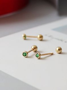 🍃--Details-- Handmade item Materials: Solid Gold (no gold filled or gold plated) Gold Kt: 14K Gemstone: Emerald  Gem colour:Green Style: Minimalist & Modern & Classic Made to Order 🍃--Description-- ❤️All components of the Earrings are genuine 14ct Gold. ❤️14K Solid Gold Emerald Green Gemstone Tiny Stud Earrings, 14K Real Gold Emerald ball end piercing, Cartilage Helix 2nd/3rd earlobe Piercings 🍃Earrings Features  ✪ 14k Solid Gold  (no gold filled or gold plated) ✪ AAA Grade Lab Grown Green Paraiba Tourmaline ✪ Earring size : 2.8*2.8mm ✪ Thickness: 0.8 mm ✪ Gold Colour : Yellow Gold ✪ Made to Order  --Others Information--  🔧Making:  WIQEE Jewels' pieces made to order. Please allow 4 - 8 business days for manufacturing. Need it sooner? Just ask and we will let you know if it's possible o Helix Studs, Earlobe Piercings, Stud Gold Earrings, Piercings Earrings, Emerald Stud Earrings, Piercing Cartilage, Emerald Gem, Real Gold Jewelry, Wrist Jewelry