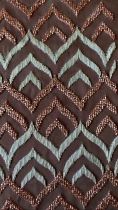 an image of a brown and blue fabric with diamond shapes on it's surface