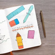 an open notebook with colored crayons and pencils