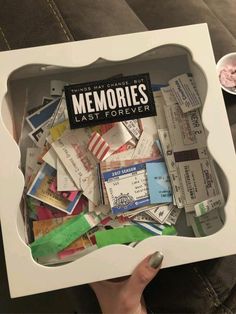 someone is holding up a box full of random items from the movies that are in it