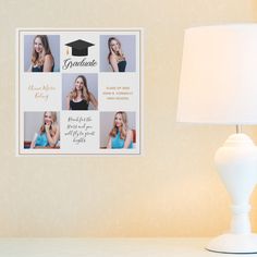 a white lamp sitting on top of a table next to a wall with pictures and graduation caps