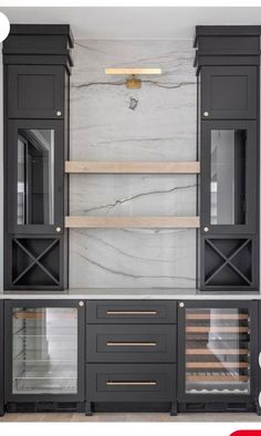 an image of a kitchen with marble counter tops and black cabinetry in the middle